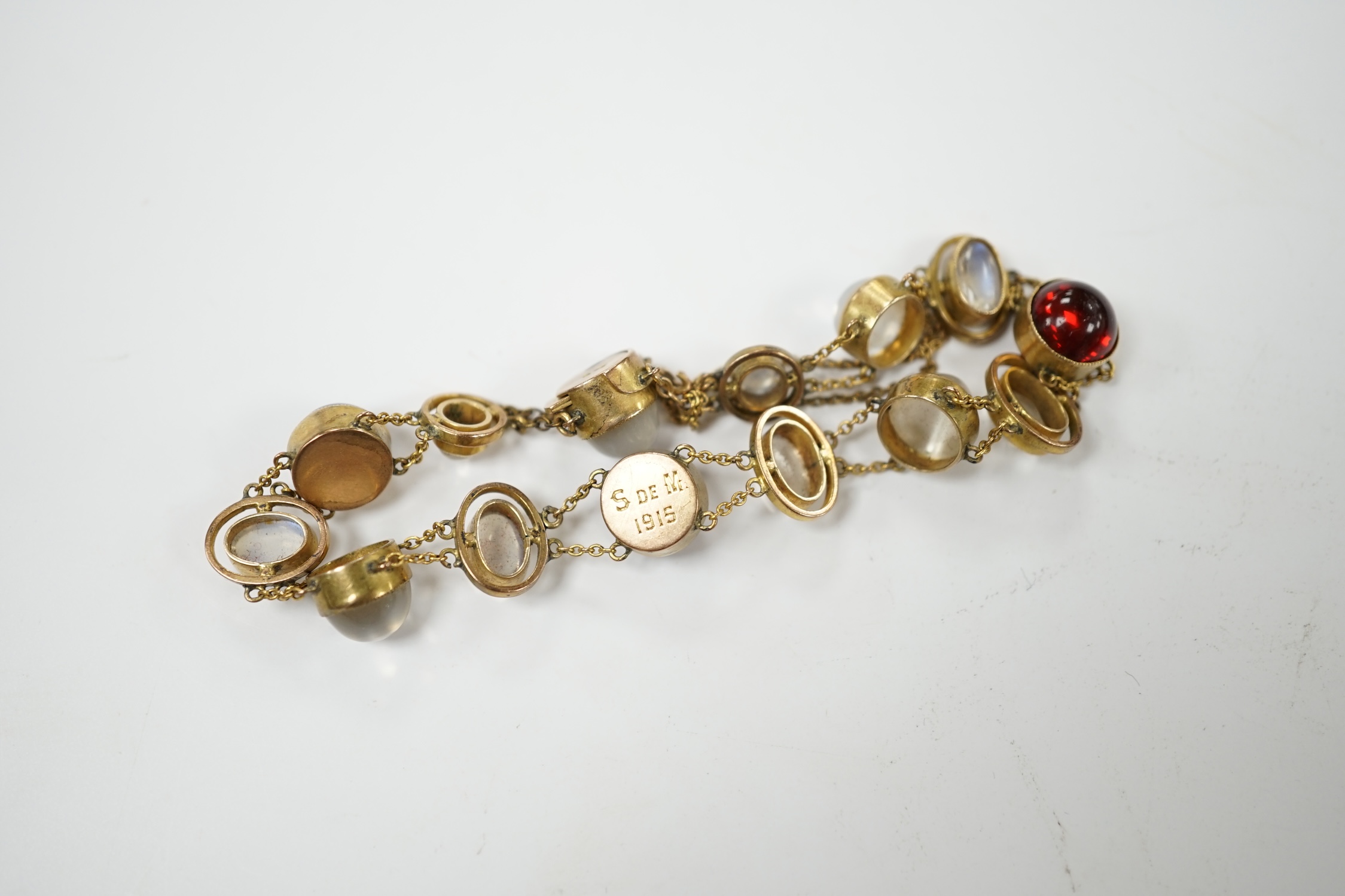 A George V 9ct, cabochon moonstone and cabochon red paste set bracelet, 16.5cm, gross weight 12 grams, Condition - fair